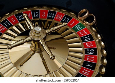 Wedding gold rings on the roulette wheel - Powered by Shutterstock