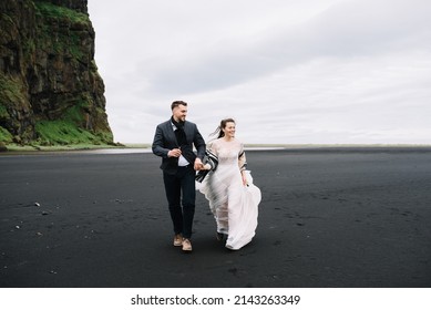 Wedding In Iceland Bride And Groom Running On The Black Beach