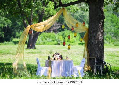 Wedding Inspiration. Set The Table In Nature, Decorated With Hanging Lamps