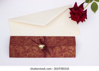 Wedding invitation with gold wedding decorative rings rose and envelope on a white background