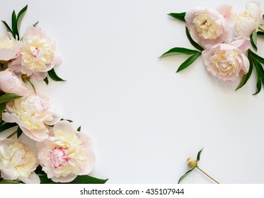 Wedding invitation or Mother's Day  background, empty space surrounded with flowers, top view peonies