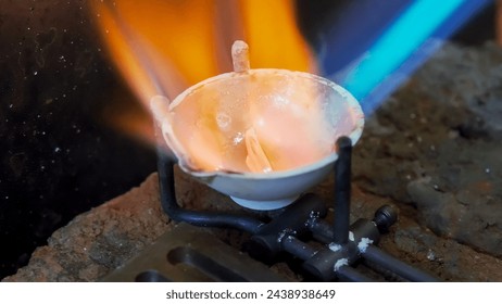 Wedding jewelry handicraft. Goldsmith melting silver with gas burner, bright flame. Ring craft. Close up. High quality photo - Powered by Shutterstock