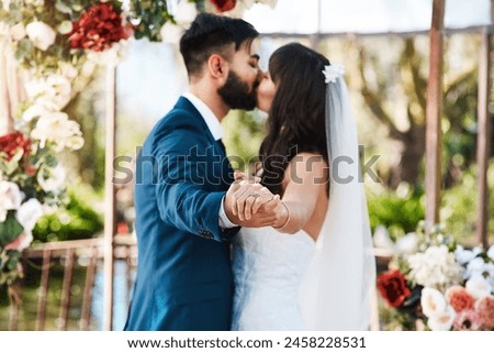 Wedding, kiss and couple holding hands in dance with love or celebration of marriage. Engagement, diamond ring and man with commitment to bride at event with trust, loyalty and respect for partner