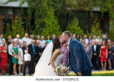 Wedding Kiss. Many Guests