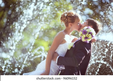 Wedding Kiss In The Park With A Fountain