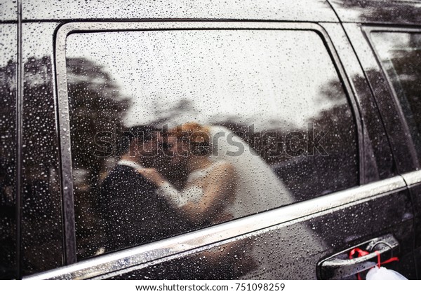 wedding kiss in the\
rain