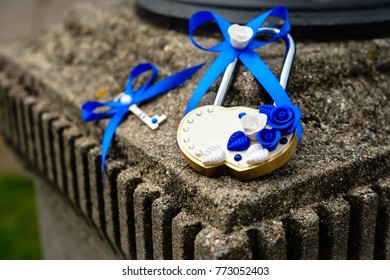 Wedding lock with key on texture bridge in park. Heart shaped padlock