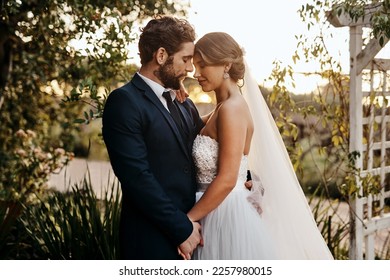 Wedding, love and bride with groom in garden for marriage, ceremony celebration and commitment. Romantic partners, trust and bridal couple hug, embrace and happy for romance, calm and peace in park