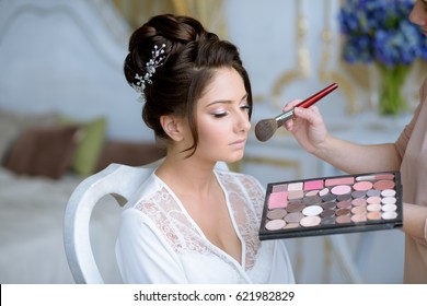 Wedding Makeup Artist Making A Make Up For Bride. Beautiful Sexy Model Girl Indoors. Beauty Woman With Curly Hair. Female Portrait. Bridal Morning Of A Cute Lady. Close-up Hands Near Face