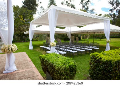 wedding marquee with bouquets of roses - Shutterstock ID 209425360