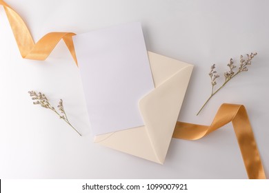 A Wedding Mock Up Concept. Wedding Invitation, Envelopes, Cards Papers On White Background With Ribbon And Decoration. Top View, Flat Lay, Copy Space