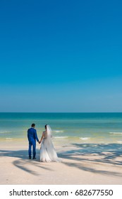Wedding on a Paradise beach. Man and woman holding hands. Phu Quoc, Vietnam.