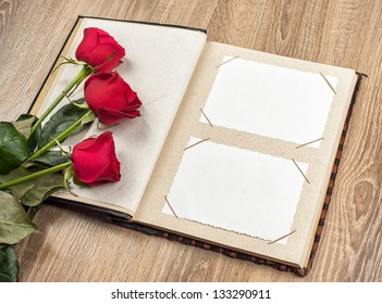 Wedding Photo Album With Roses On A Wooden Background