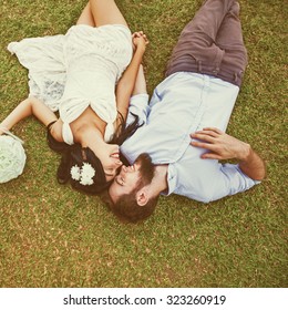 Wedding Photo Of Couple On A Grass. 