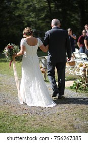 Wedding Photography: Bride Being Walked Down The Aisle By Her Father Outdoor Processional