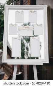 Wedding Photography: Classic Seating Chart  on a White Wooden Frame, copy space