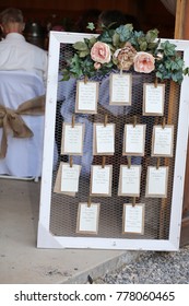 Wedding Photography: Rustic Seating Chart with Floral Decoration on a White Wooden Frame