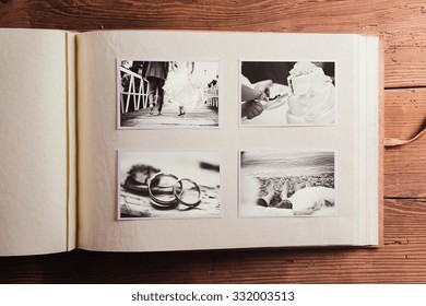Wedding Photos In Album. Studio Shot On Wooden Background.