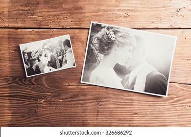 Wedding photos laid on a table. Studio shot on wooden background. - Shutterstock ID 326686292