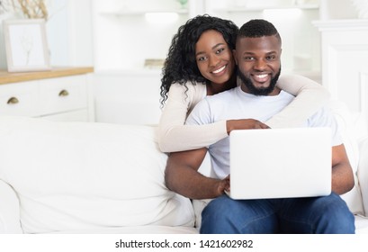 Wedding Planning. Happy African American Man And Woman Using Laptop At Home Together, Empty Space