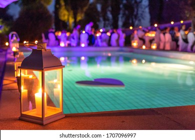 Wedding Reception By The Pool At Night, Lit By Candles.