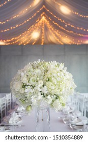 Wedding reception set up with white flowers and candles.