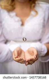 Wedding Ring Floating In Hands 