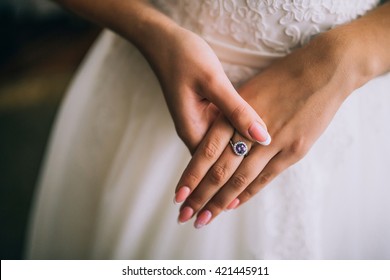A wedding ring on the finger of the bride.