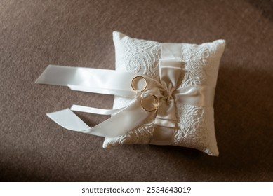 A wedding ring pillow elegant ceremony accessory, often beautifully adorned, that carries the wedding rings during the ceremony, symbolizing the union and eternal love of the couple. - Powered by Shutterstock