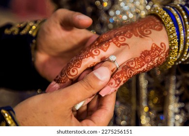 A wedding ring is a symbol of love and commitment exchanged by two individuals during their wedding ceremony.