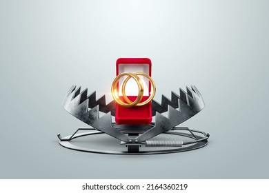 Wedding rings in a bear trap, close-up. The concept of love, relationship, addiction, marriage, separation, heartache. mixed media - Shutterstock ID 2164360219