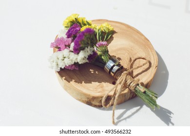 wedding rings with a buttonhole on a disk of wood