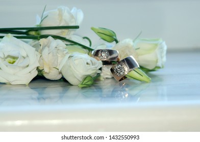 
wedding rings and flowers on the marble windowsill - Shutterstock ID 1432550993