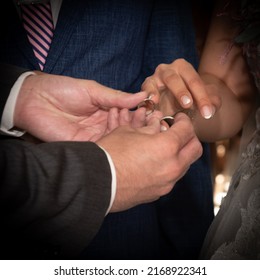 Wedding Rings In Hands Of Groom And Bride At Wedding. Orthodox Marriage Engagement