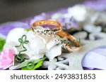 wedding rings lie on flowers, wedding ceremony, jewelry, diamonds, diamond rings, precious jewelry, gold, purple jewelry