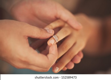 Wedding rings. Man giving an engagement ring to his girlfriend. Boyfriend Surprised Her Girlfriend With Engagement Ring In Restaurant - Shutterstock ID 152589473