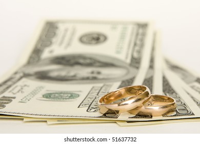 Wedding Rings And Money On A White Background