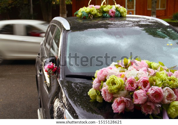 Wedding. Wedding rings on a wedding car. car\
decorated with flowers