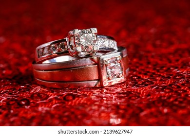 Wedding Rings On Glitter Red Background.  Modern Wedding Ring. Beautiful Wedding Or Engagement Ring Symbol.