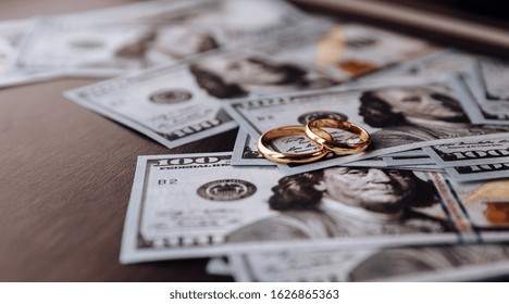 Wedding Rings On Money Background