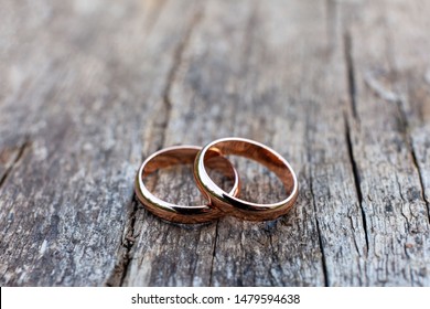 Wedding Rings On An Old Wooden Surface, Rustic Style