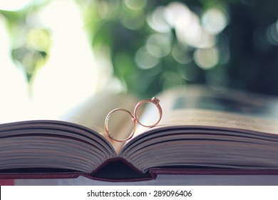 Wedding Rings On Open Book