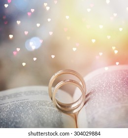 Wedding Rings On Open Book