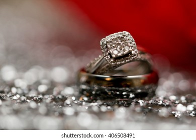 Wedding Rings On Silver Glitter Background.