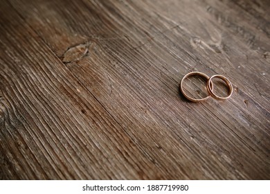 wedding rings on a wooden table
