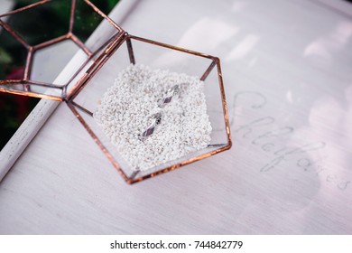 Wedding Rings Put In A Glass Box With White Sand