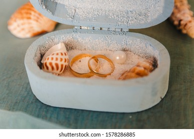 Wedding Rings In A Rustic Box With White Sand And Seashells, For The Wedding Ceremony Or Vow Renewal