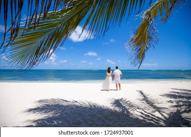 Wedding Romantic Couple On The Beach During Destination Wedding Matrimonial Marriage Ceremony In Dominican, Punta Cana, Tropical Caribbean Landscape With Blue Sea And Sky. Unity Love Family Concept 