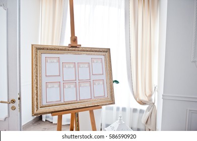 Wedding seating chart on the easel at light restaurant.