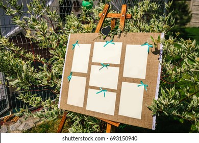 Wedding seating chart on the easel in the park. Outdoors.